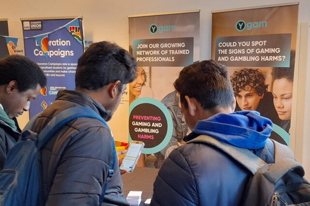 Two students looking at a Ygam poster