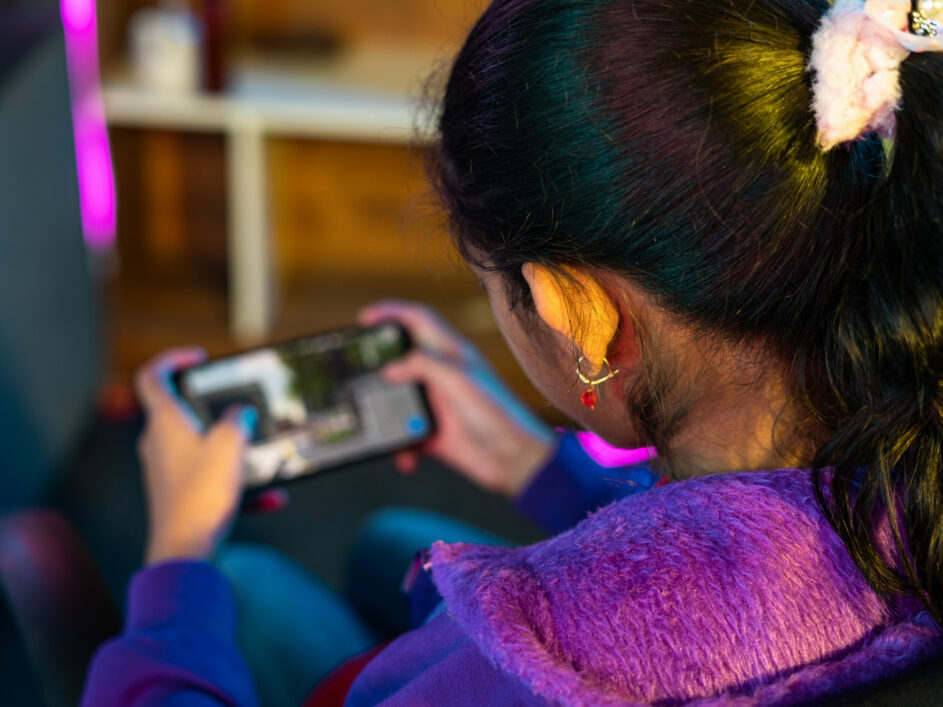 A girl playing a game on her phone