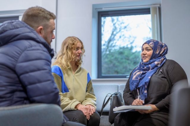 Foster care social worker in a meeting with foster parent and young person
