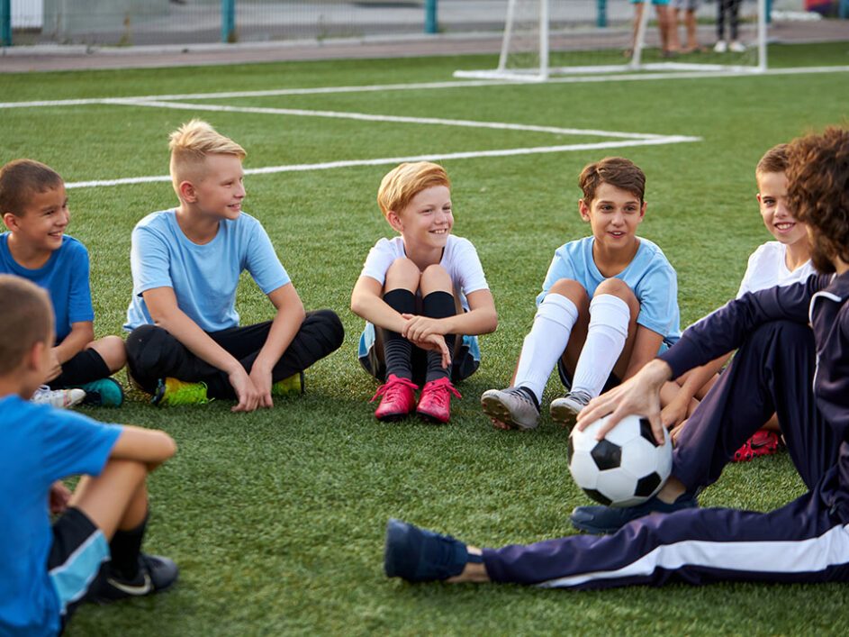 young team of sportive boys take a break during football competition
