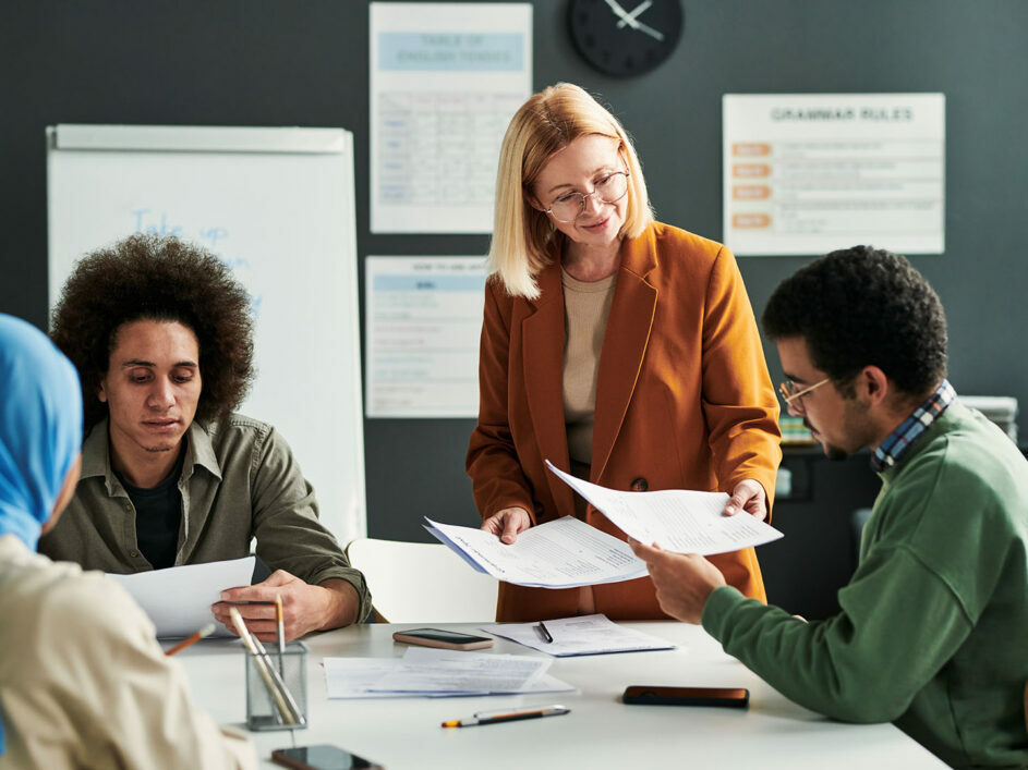 Students in classroom being passed papers