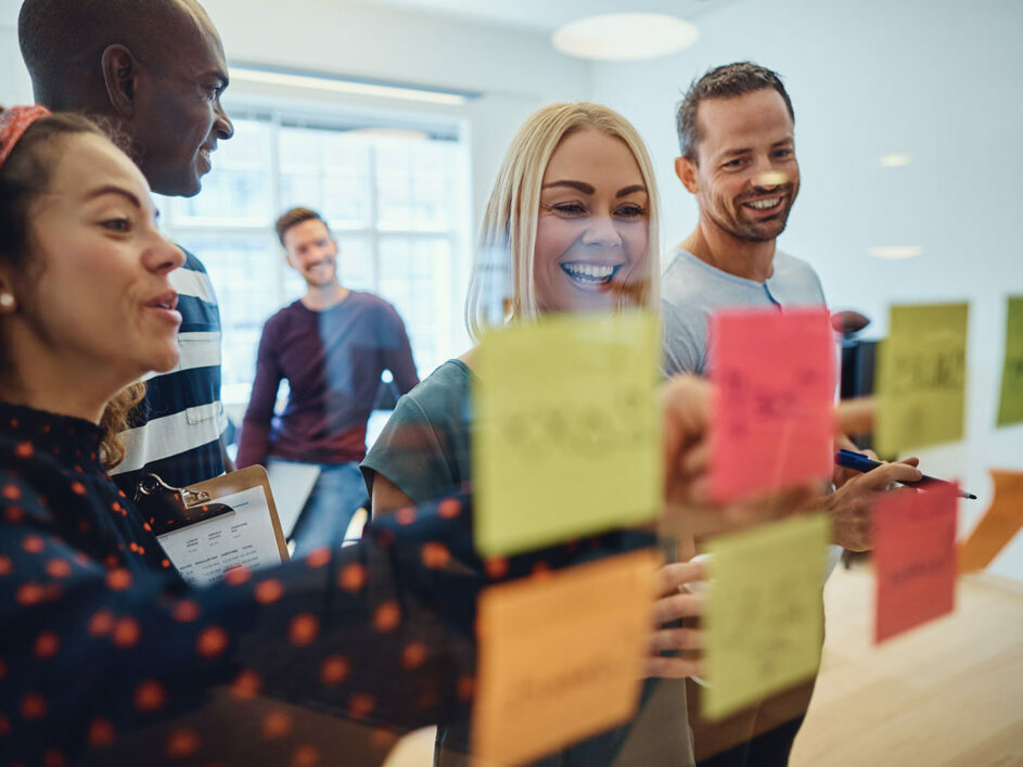 Diverse team using post-it notes