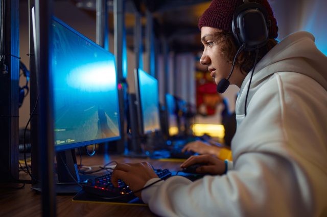 Teenage boy playing computer game