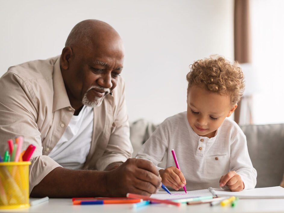 Grandfather colouring in with grandchild