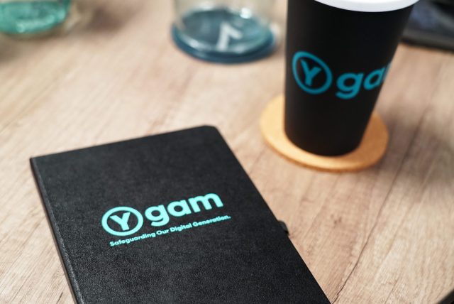 Ygam branded book and cup